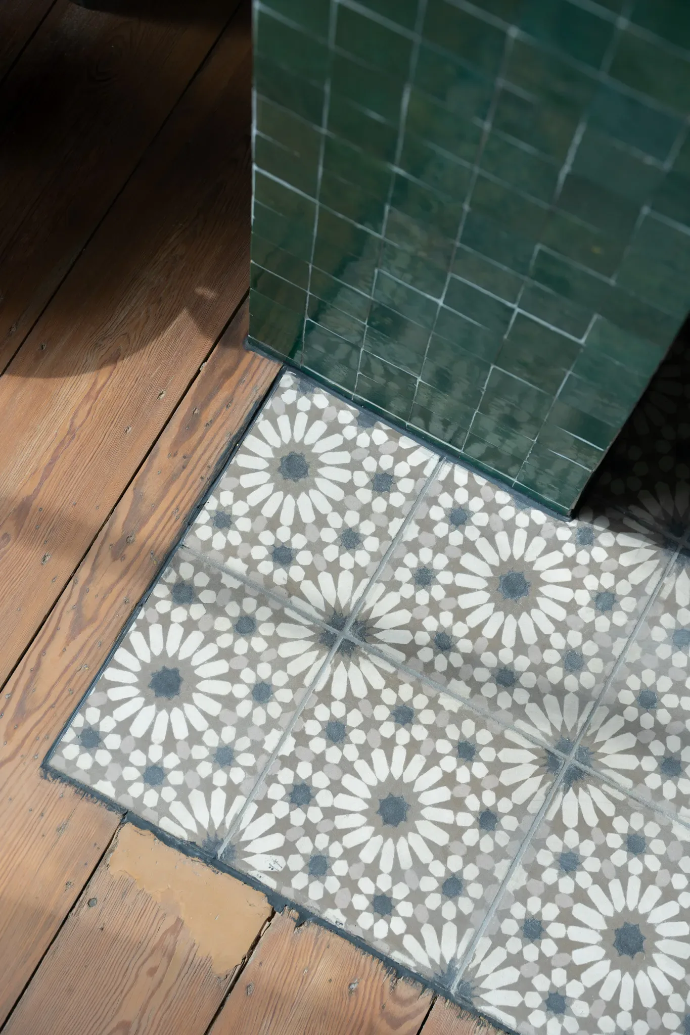 Feu — raccord entre cheminée verte, sol à motifs et plancher bois
